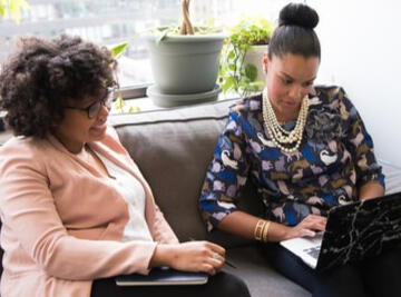 Two women conferring; provided by generous artist at Unsplash.com