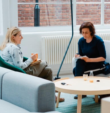 Two women checking notes; provided by generous artist at Unsplash.com